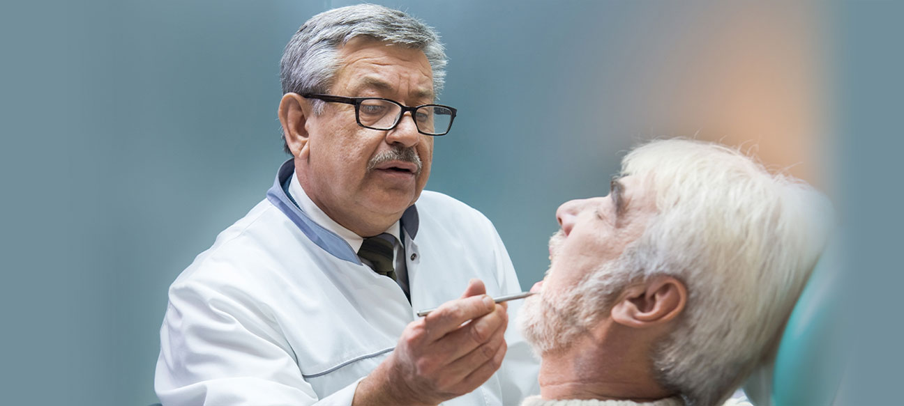 dentist is checking old guy mouth