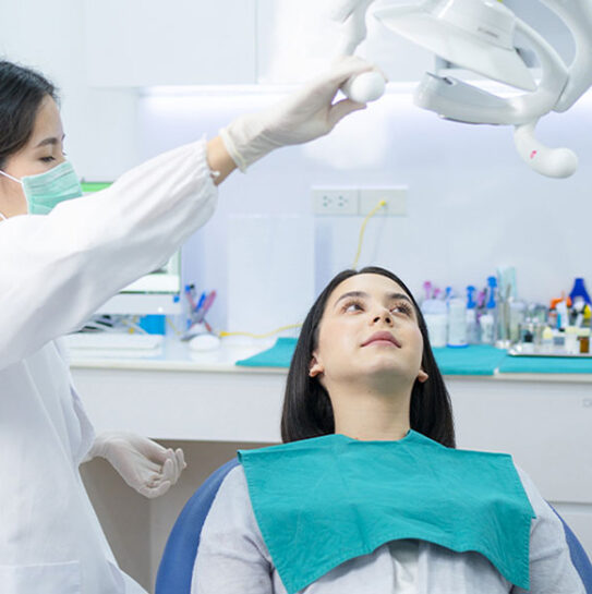 dentist is setup to examine girl mouth