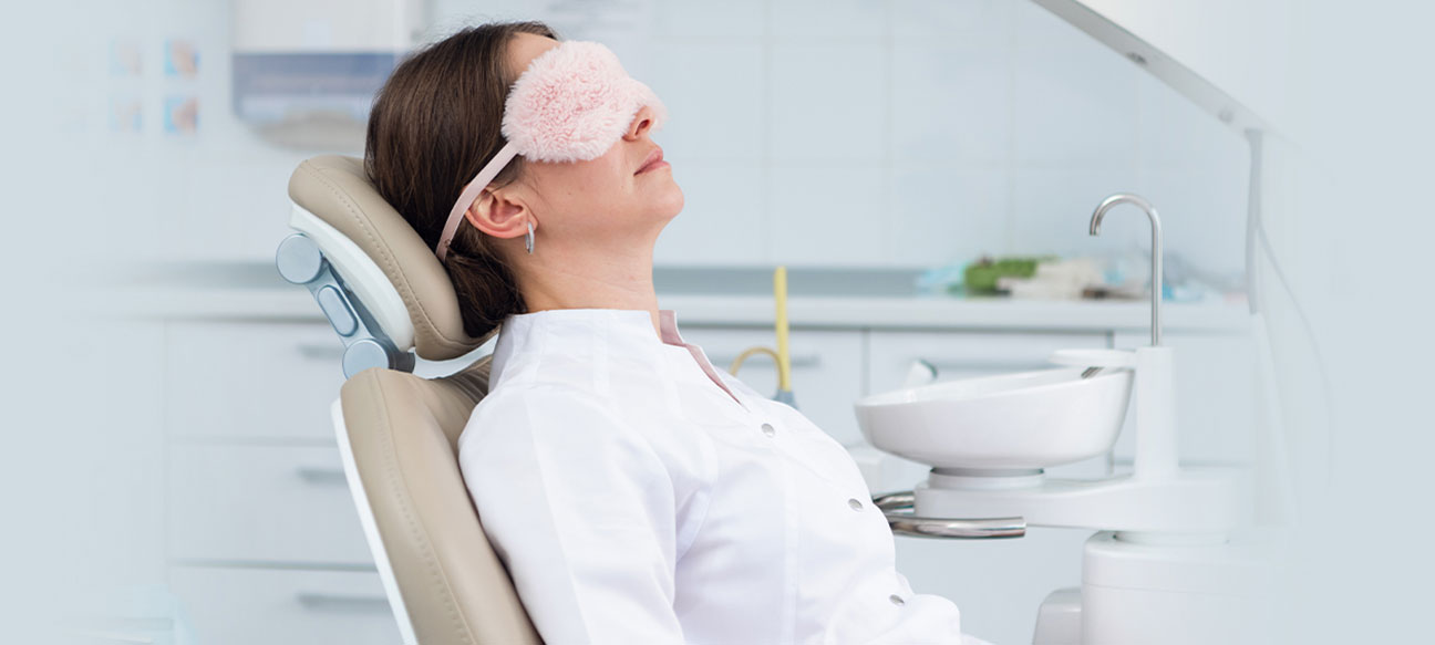 lady is wearing eyes mask and sleeping on dental chair