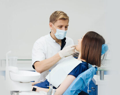 dentist in examine girl mouth 